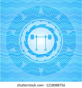 barbell on rack icon inside water representation style emblem.