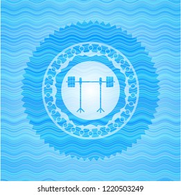 barbell on rack icon inside water style emblem.