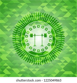barbell on rack icon inside green emblem. Mosaic background