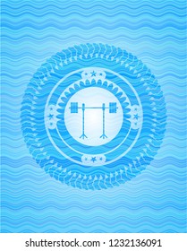 barbell on rack icon inside water wave badge.