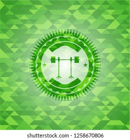 barbell on rack icon inside green emblem with mosaic background