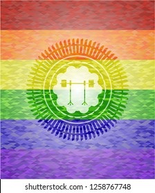 barbell on rack icon inside emblem on mosaic background with the colors of the LGBT flag