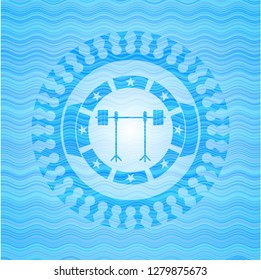 barbell on rack icon inside light blue water style badge.