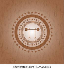 barbell on rack icon inside realistic wood emblem