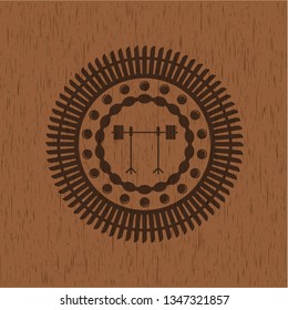 barbell on rack icon inside badge with wood background