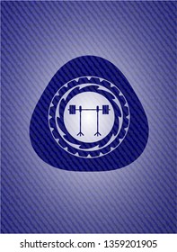 barbell on rack icon inside emblem with denim texture