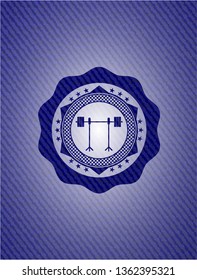barbell on rack icon inside emblem with jean background