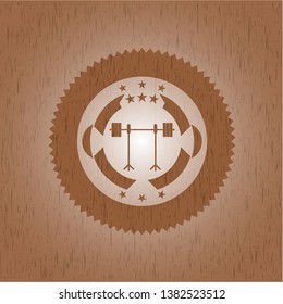 barbell on rack icon inside wooden emblem. Vintage.