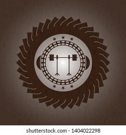 barbell on rack icon inside badge with wood background