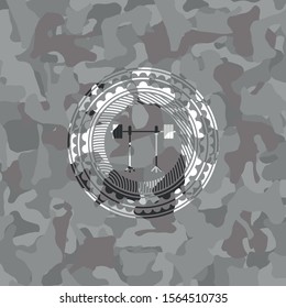 barbell on rack icon inside grey camo emblem
