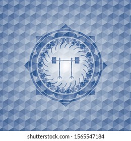 barbell on rack icon inside blue emblem with geometric pattern background.