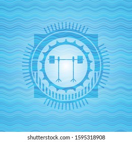 barbell on rack icon inside water wave badge.