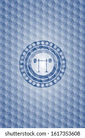 barbell on rack icon inside blue emblem with geometric background.