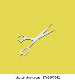 
barber scissors on a yellow background