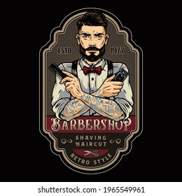 Barbershop retro colorful badge with trendy tattooed mustached and bearded barber holding comb and electrical hair clipper in crossed hands isolated vector illustration
