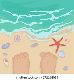 bare feet of a man and various seashells on the sea shore near the surf waves