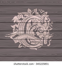 Baroque letters of the alphabet in upper case letters on wooden background. Letter C. Vector illustration