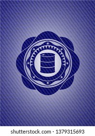 barrel icon inside badge with denim background