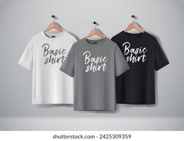 Basic Black, gray and white short sleeve T-Shirts Mock-up clothes set hanging isolated on wall. Front side view with lettering for your design or logo.