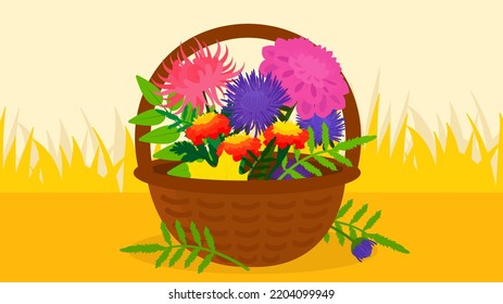 basket with autumn flowers on a background of yellow grass