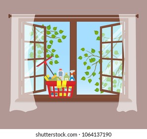 Basket with detergents on the windowsill. Cleaning concept. Open window with curtains on a brown background. Outside the window there are tree branches with green leaves on a blue sky background