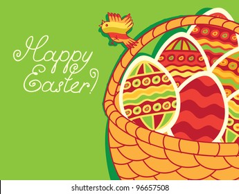 basket of Easter eggs on green background