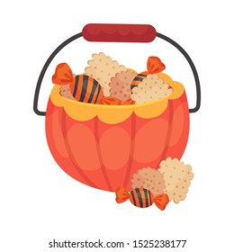 Basket of pumpkins with sweets and a handle for Halloween.