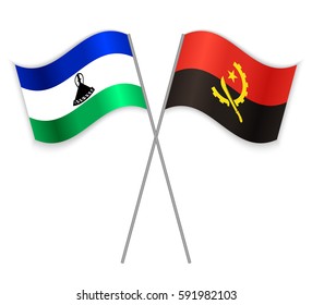 Basotho and Angolan crossed flags. Lesotho combined with Angola isolated on white. Language learning, international business or travel concept.