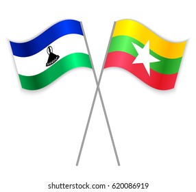 Basotho and Burmese crossed flags. Lesotho combined with Burma isolated on white. Language learning, international business or travel concept.