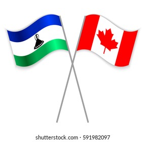 Basotho and Canadian crossed flags. Lesotho combined with Canada isolated on white. Language learning, international business or travel concept.