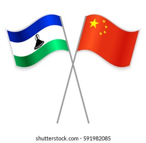 Basotho and Chinese crossed flags. Lesotho combined with China isolated on white. Language learning, international business or travel concept.