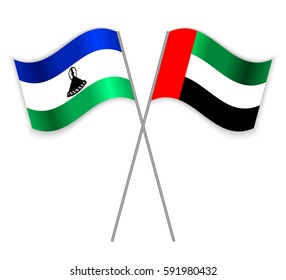 Basotho and Emirian crossed flags. Lesotho combined with United Arab Emirates isolated on white. Language learning, international business or travel concept.
