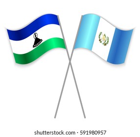 Basotho and Guatemalan crossed flags. Lesotho combined with Guatemala isolated on white. Language learning, international business or travel concept.