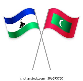 Basotho and Maldivian crossed flags. Lesotho combined with Maldives isolated on white. Language learning, international business or travel concept.