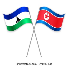 Basotho and North Korean crossed flags. Lesotho combined with North Korea isolated on white. Language learning, international business or travel concept.