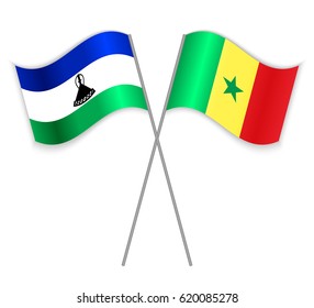 Basotho and Senegalese crossed flags. Lesotho combined with Senegal isolated on white. Language learning, international business or travel concept.