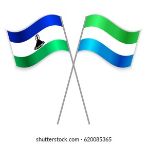 Basotho and Sierra Leonean crossed flags. Lesotho combined with Sierra Leone isolated on white. Language learning, international business or travel concept.