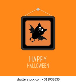 Bat in picture frame on nail. Happy Halloween card. Orange background Flat design Vector illustration