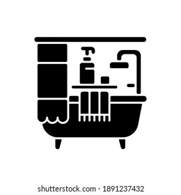 Bathroom black glyph icon. Bath accessories. Bathtub and shower. Plumbing. Freestanding tub. Shower curtains. Shampoo dispenser. Silhouette symbol on white space. Vector isolated illustration