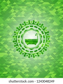 bathtub icon inside green emblem with triangle mosaic background