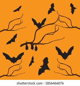 Bats are on the tree branch at the halloween night.