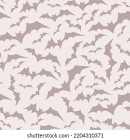 Bats vector on a nude color background, powder pink, monochrome, cartoon character. Seamless pattern. Halloween symbol circling flying bats. The illustration is hand drawn.