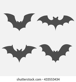 Bats vector set isolated on white background. Dark silhouettes of bats flying in a flat style. 