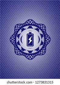battery charging icon inside badge with denim background