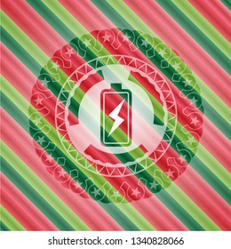 battery charging icon inside christmas badge.