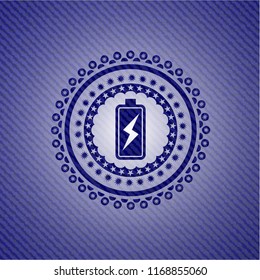 battery charging icon inside emblem with denim texture