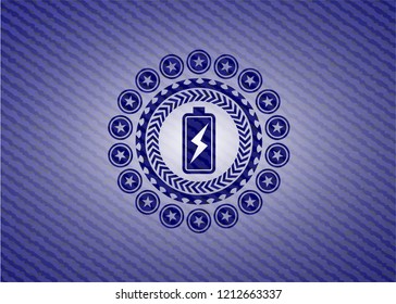 battery charging icon inside emblem with denim high quality background