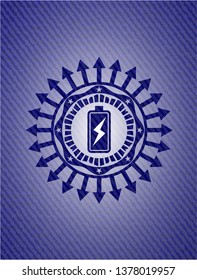 battery charging icon inside emblem with denim texture