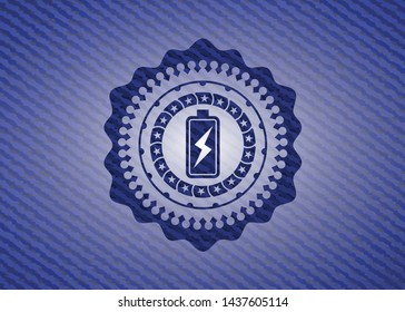 battery charging icon inside emblem with denim high quality background