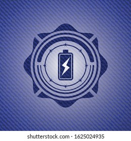 battery charging icon inside emblem with denim high quality background